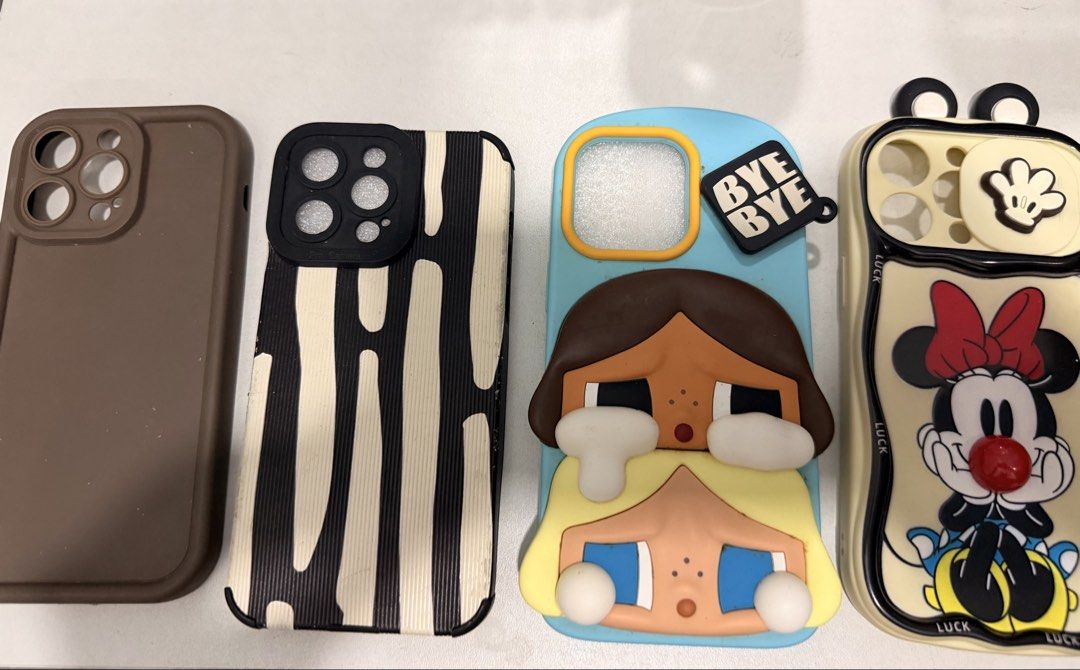 Iphone 14 promax cases (Category: Cases & Sleeves) located in Caloocan City. Submitted by minnieellezirkenna (Listing ID 1467570511, Image 1). Description: Iphone 14 promax cases 1. Crybaby Case authetic bought from popmart Macau 2. Brown case plain 3. Black and white print 4. Minnie Mouse.