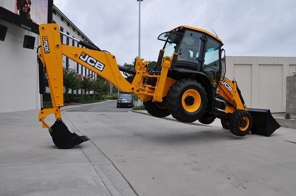 JCB 3CX Backhoe Loader (Category: Construction Tools & Equipment) located in Caloocan City. Submitted by xcmgmachinery (Listing ID 1467369585, Image 1). Description: - Model: Yellow JCB 3CX backhoe loader - Equipment Type: Heavy-duty construction machinery - Attachments: Front loader bucket and extended rear excavator arm with ground-touching bucket - Mobility: Equipped with large, heavy-duty tires - Cab Features: Full enclosure with tinted windo