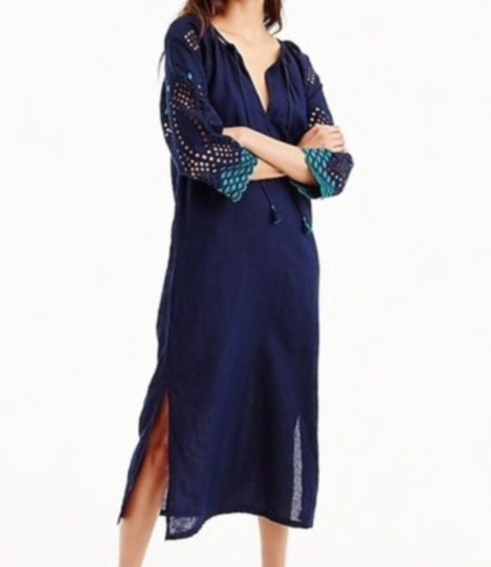 j.crew Navy Blue Dress Medium (Category: Dresses) located in Davao. Submitted by parenasnic86577 (Listing ID 1467601794, Image 2). Description: - Brand: J.Crew - Size: Medium - Color: Navy blue with green and turquoise eyelet embroidery on sleeves - Neckline: V-neck with front tie string closure - Fit: Relaxed fit with side slits at the hemline - Length: Mid-length - Ideal for: Warm weather, casual outings, or beach cover-up.