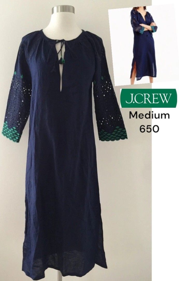 j.crew Navy Blue Dress Medium (Category: Dresses) located in Davao. Submitted by parenasnic86577 (Listing ID 1467601794, Image 1). Description: - Brand: J.Crew - Size: Medium - Color: Navy blue with green and turquoise eyelet embroidery on sleeves - Neckline: V-neck with front tie string closure - Fit: Relaxed fit with side slits at the hemline - Length: Mid-length - Ideal for: Warm weather, casual outings, or beach cover-up.
