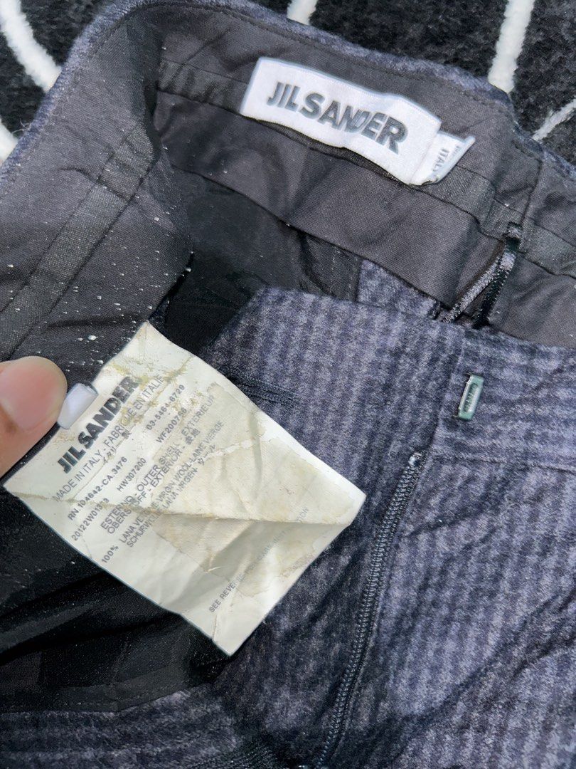 JIL-SANDER (Category: Other Bottoms) located in Koronadal. Submitted by lokiefinds (Listing ID 1467365234, Image 3). Description: These are a pair of Jil Sander micro-checked or pinstriped trousers featuring a relaxed, straight-leg cut and a button-closure waistband, laid out on a black and white Chrome Hearts-style graphic blanket..