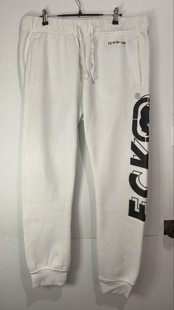 JOGGER PANTS (Category: Joggers) located in Jaen. Submitted by oshimamark58418 (Listing ID 1467407947, Image 1). Description: - Brand: Ecko Unltd. - Color: White with striking black logo print on the leg - Size: XL (Waist 32 to 36, Length 40) - Features: Garterized waistband with adjustable drawstrings, functional side pockets, and back pocket - Material: Comfortable cotton-blend fleece, soft and cozy - Condition: Well-maintained, pre-loved stree