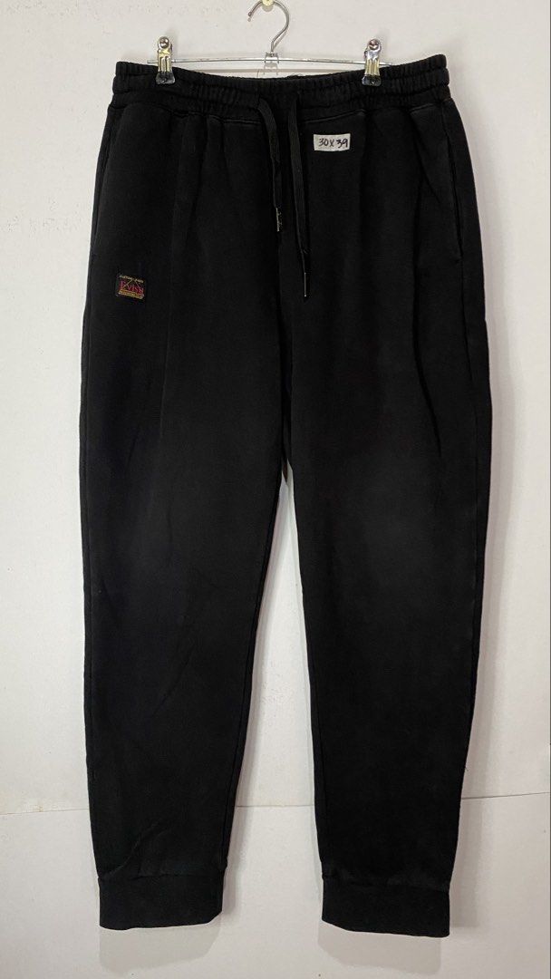 JOGGER PANTS (Category: Joggers) located in Jaen. Submitted by oshimamark58418 (Listing ID 1467408982, Image 2). Description: - Brand: EVISU - Color: Black - Size: Small / US 30 (marked 30x39) - Design: Bold Osaka print on the back and custom EVISU heritage patch on the front - Features: Elastic waistband with drawstring, ribbed cuffs, and side pockets - Condition: 7/10 (Pre-loved, well-maintained streetwear jogger).