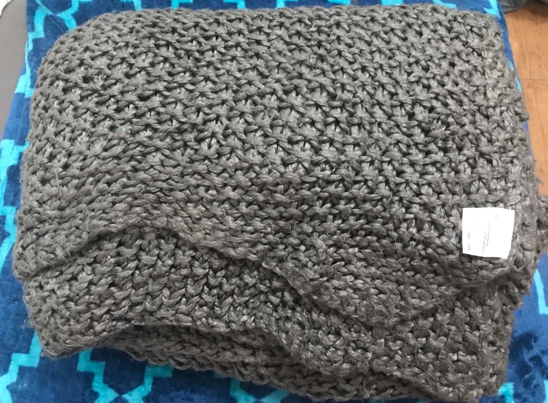 John Lewis Dark Grey Chunky Knit Throw Blanket (Category: Bedding & Towels) located in Imus. Submitted by stop_shop7 (Listing ID 1467419407, Image 2). Description: - Brand/Item: John Lewis dark grey chunky knit throw blanket - Texture: Thick, textured yarn woven throughout for a cozy look - Color: Neutral solid dark grey, fits any living room or bedroom decor - Comfort: Heavyweight style designed to keep you warm on cold nights - Condition: Clean