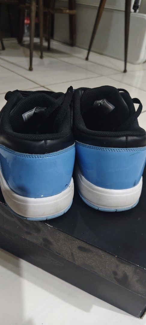 Jordan Nu Retro 1 Low Black University Blue (Category: Sneakers) located in Las Pinas. Submitted by jonjaymanese20 (Listing ID 1467452887, Image 3). Description: - Model: Jordan Nu Retro 1 Low - Colorway: Black and University Blue - Size: US 9.5 - Inclusions: Original box included - Design: Classic low top with debossed Air Jordan branding and striking patent blue toe boxes and heel panels - Condition: Soles show minor wear with slight yellowing 