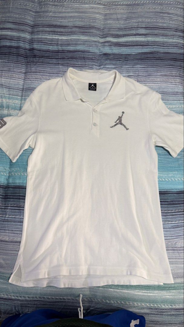 Jordan White Polo Shirt Size XL (Category: Tshirts & Polo Shirts ) located in Quezon City. Submitted by kobeeeee_12 (Listing ID 1467514621, Image 1). Description: - Brand: Jordan - Color: White - Size: XL - Material: 100% Cotton - Design: Classic collar with front button placket - Details: Signature Jumpman logo on the left chest and unique number detail on the sleeve - Condition: Brand new with tags - Care instructions included on the inner tag.