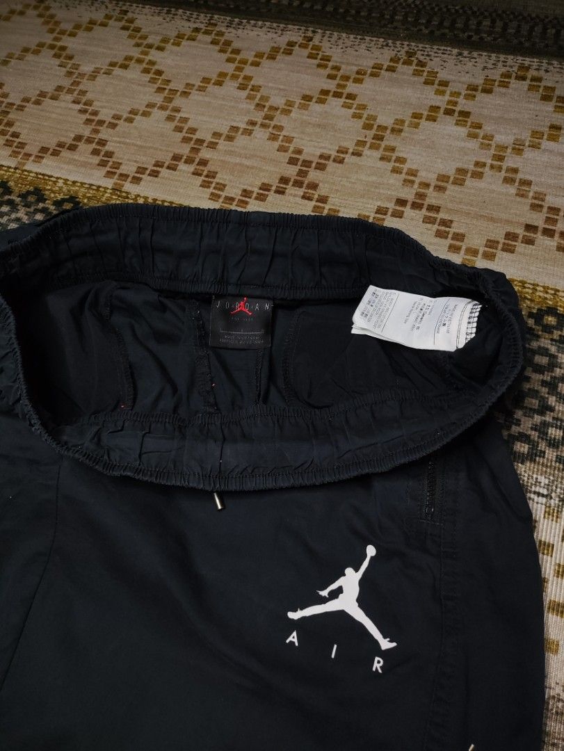 Jordan Woven Pants (Category: Joggers) located in Taguig. Submitted by althriftdailyloots94 (Listing ID 1467483520, Image 3). Description: - Authentic Jordan Air sweatpants in classic black - Size: Large (Product code: AV1841-010, Made in Vietnam) - Iconic white Jumpman logo on the left leg - Adjustable elastic waistband with drawstring - Convenient zippered side pockets to keep your items secure - Comfortable elastic ankle cuffs - Soft, premium 