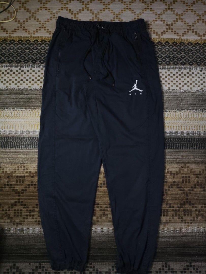 Jordan Woven Pants (Category: Joggers) located in Taguig. Submitted by althriftdailyloots94 (Listing ID 1467483520, Image 1). Description: - Authentic Jordan Air sweatpants in classic black - Size: Large (Product code: AV1841-010, Made in Vietnam) - Iconic white Jumpman logo on the left leg - Adjustable elastic waistband with drawstring - Convenient zippered side pockets to keep your items secure - Comfortable elastic ankle cuffs - Soft, premium 