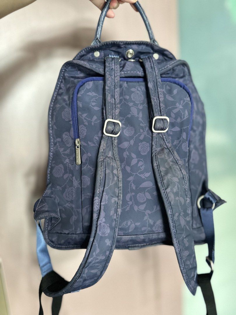 Kanana Project Blue Rose Pattern Backpack (Category: Backpacks) located in Mandaluyong City. Submitted by TheWeekendProject (Listing ID 1467421682, Image 2). Description: - Color & Design: Navy blue with an all-over rose and lace pattern and metallic silver trim - Interior: Vibrant pink lining with convenient slip pockets - Storage: Double zipper main compartment and a front zip pocket - Comfort & Carry: Top grab handle and adjustable shoulder st