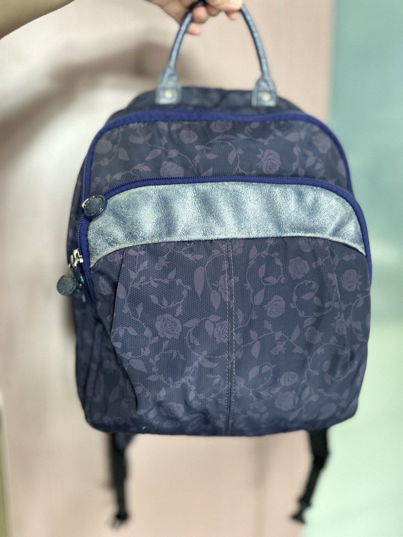 Kanana Project Blue Rose Pattern Backpack (Category: Backpacks) located in Mandaluyong City. Submitted by TheWeekendProject (Listing ID 1467421682, Image 1). Description: - Color & Design: Navy blue with an all-over rose and lace pattern and metallic silver trim - Interior: Vibrant pink lining with convenient slip pockets - Storage: Double zipper main compartment and a front zip pocket - Comfort & Carry: Top grab handle and adjustable shoulder st
