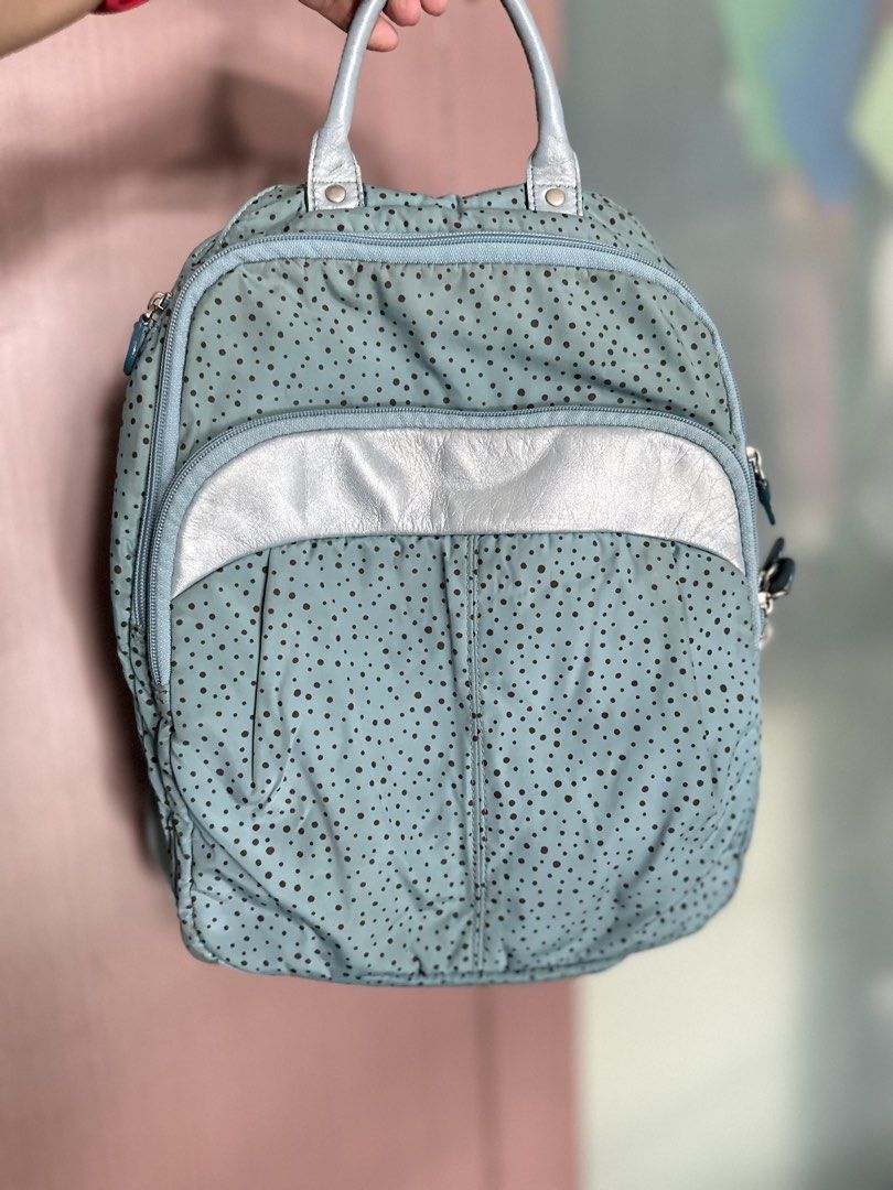 Kanana Project Light blue polka dot backpack with pink interior (Category: Backpacks) located in Mandaluyong City. Submitted by TheWeekendProject (Listing ID 1467422436, Image 1). Description: - Color: Light blue with brown polka dots and a metallic silver front pocket accent - Interior: Soft pink fabric with multiple slip pockets, a side pocket, and a zipped mesh pocket - Design: Dual zippers and a convenient top handle - Usage: Ideal daily bag 