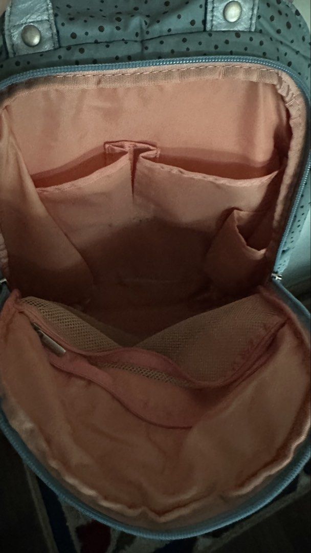 Kanana Project Light blue polka dot backpack with pink interior (Category: Backpacks) located in Mandaluyong City. Submitted by TheWeekendProject (Listing ID 1467422436, Image 3). Description: - Color: Light blue with brown polka dots and a metallic silver front pocket accent - Interior: Soft pink fabric with multiple slip pockets, a side pocket, and a zipped mesh pocket - Design: Dual zippers and a convenient top handle - Usage: Ideal daily bag 