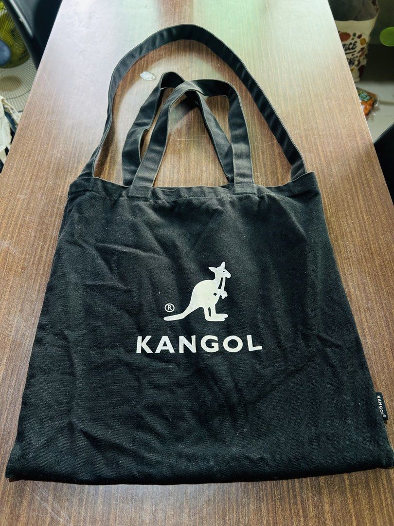 Kangol Black Canvas Tote Bag (Category: Tote Bags) located in Manila. Submitted by starbalesukandjapansurplus (Listing ID 1467559911, Image 2). Description: - Brand: Kangol - Color: Classic black canvas with iconic white kangaroo logo - Material: 100% cotton (checked via inside tag) - Design: Versatile dual handles and comfortable shoulder straps - Usage: Spacious and durable, ideal for daily school or work essentials - Condition: Good and ready 