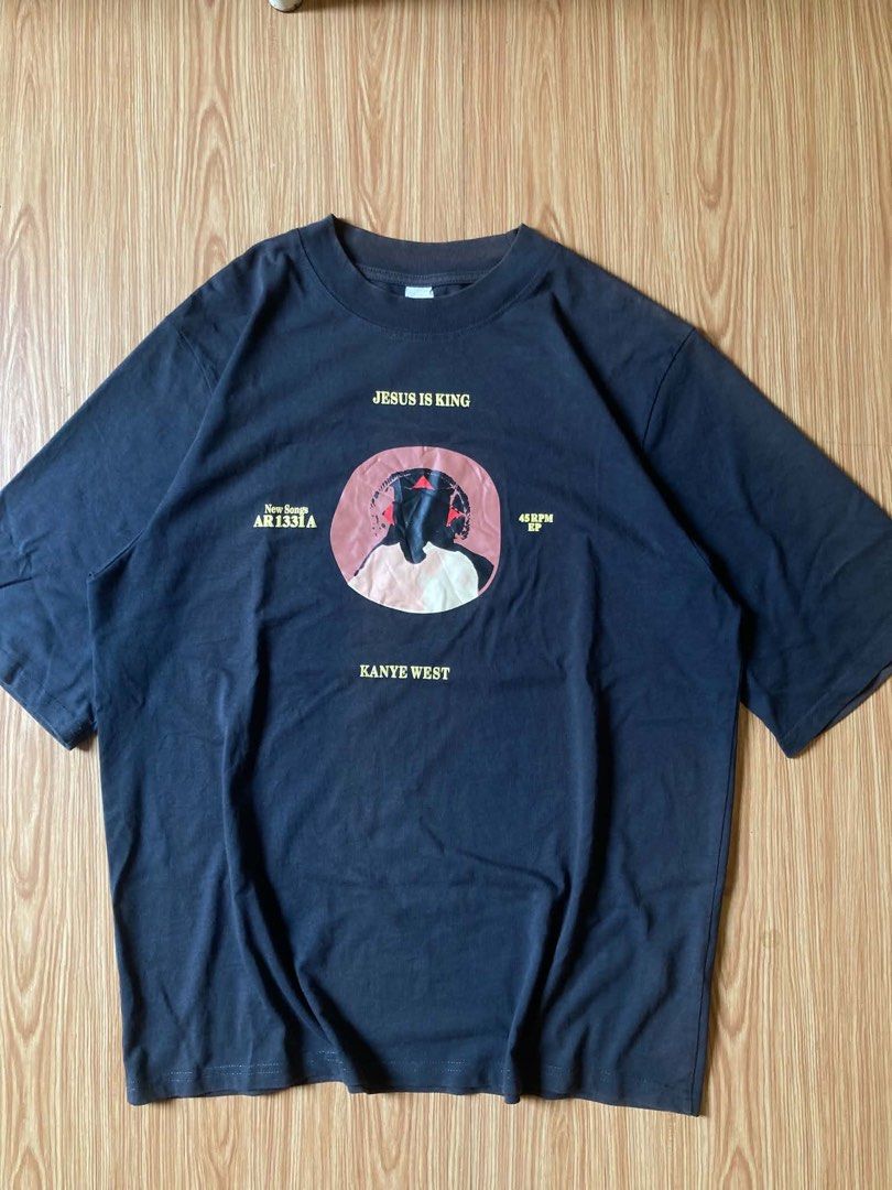 KANYE WEST (Category: Activewear) located in Lucena. Submitted by zhildaze (Listing ID 1467415759, Image 1). Description: Kanye West “Jesus is King” Tee • Features a design inspired by the Vinyl Record Format • Puff Print • Beefy Neck AUTHENTIC Size: (23W) (29L) XL Condition: 9.5/10.