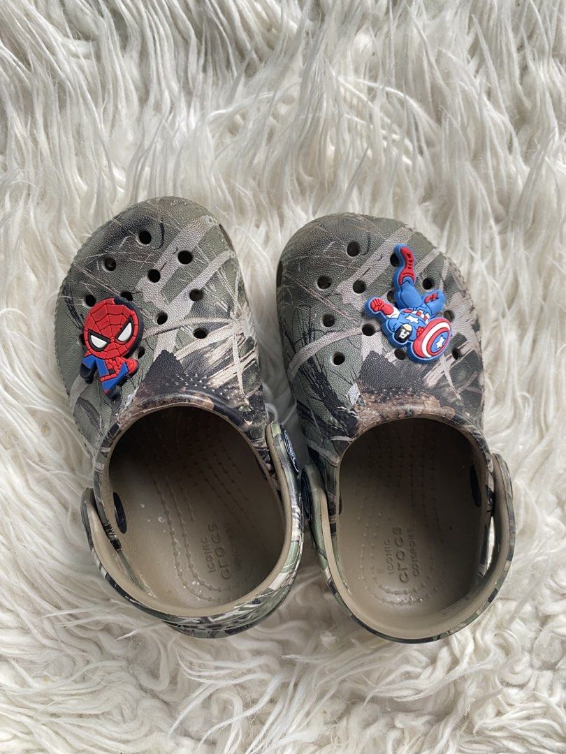 Kids Crocs Camo with Marvel Jibbitz Size C7 (Category: Babies & Kids Fashion) located in Tabaco. Submitted by camila_p (Listing ID 1467442979, Image 3). Description: - Kids Crocs in cool camo pattern - Size C7 molded on outsole, 11-13cm - Includes authentic Spider-Man and Captain America Jibbitz charms - Features Iconic Crocs Comfort cushioning - Easy slip-on style with pivoting heel straps.