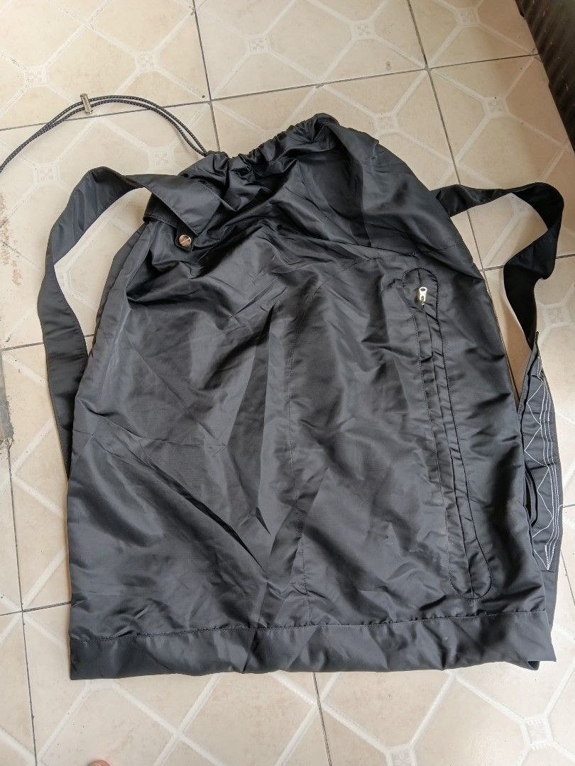 Kiko Kostadinov Black Shoulder Bag (Category: Shoulder Bags) located in Manila. Submitted by grandflower-547aee (Listing ID 1467391081, Image 1). Description: - Brand: Kiko Kostadinov - Color: Black - Material: Durable synthetic fabric - Closure: Drawstring top with branded snap button - Hardware: Premium riri zippers on exterior pocket - Strap: Adjustable for custom fit - Details: Includes interior label - Style: Minimalist design, perfect as an
