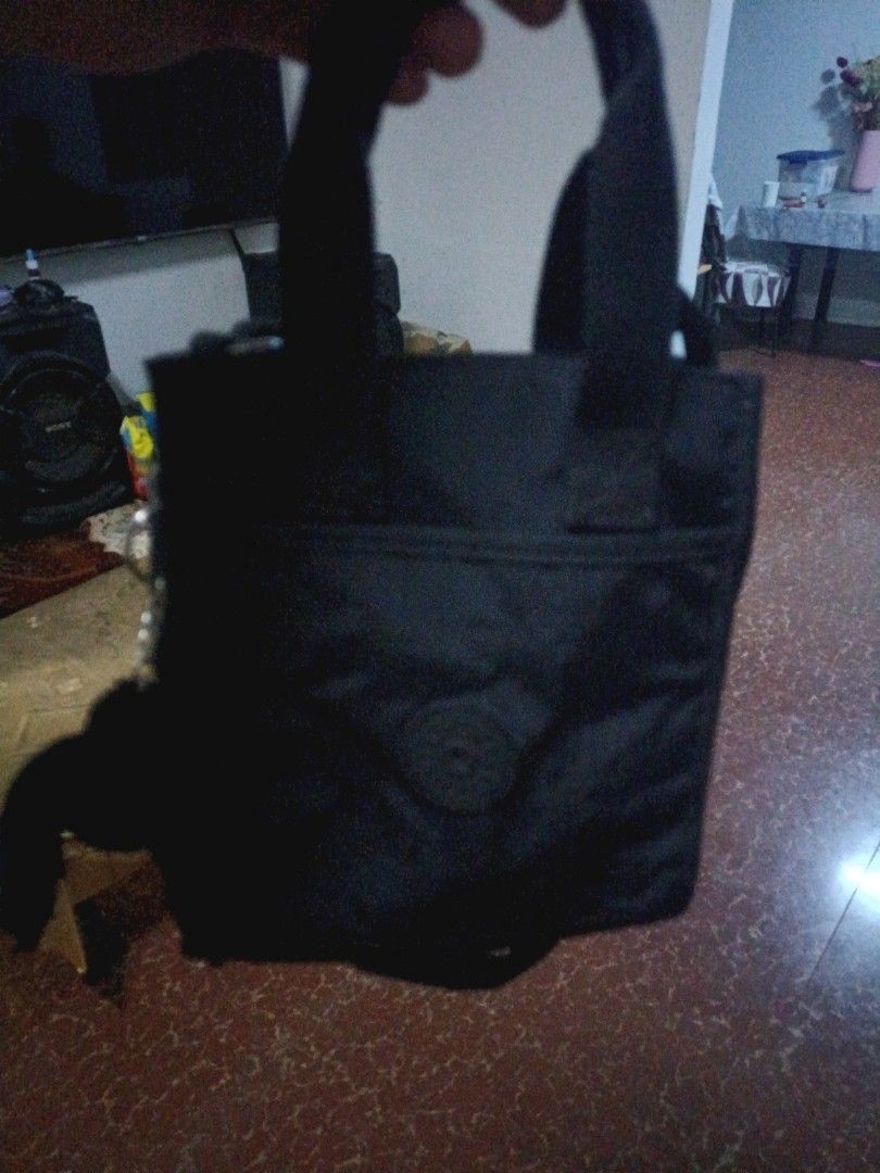 Kipling black crossbody bag with top handles (Category: Cross-body Bags) located in Taal. Submitted by zildreiven (Listing ID 1467392679, Image 2). Description: - Brand: Kipling - Color: Classic Black - Material: Durable crinkled nylon - Features: Dual top handles and adjustable/detachable shoulder strap - Compartments: Secure zip-top closure, light grey interior lining, internal zip pocket, and open slip pockets - Exterior: Front zip pocket with