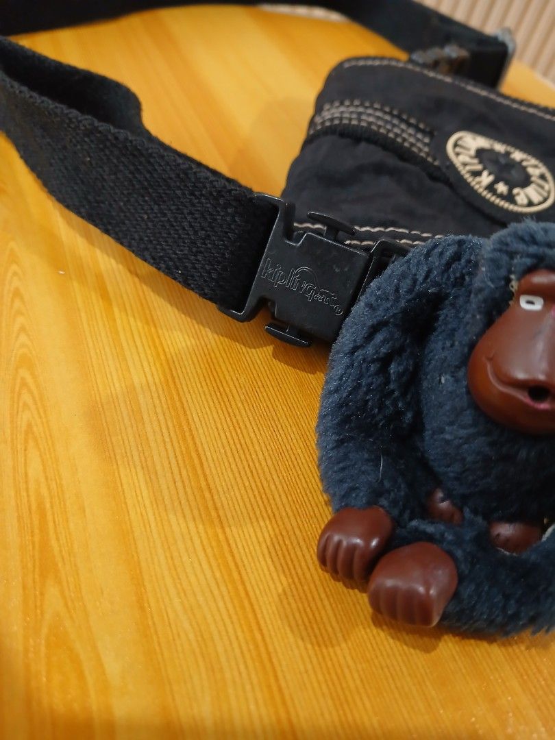 Kipling Black Crossbody Bag with Monkey Keychain (Category: Cross-body Bags) located in Daraga. Submitted by thethriftcity2024 (Listing ID 1467407648, Image 3). Description: - Authentic black Kipling crossbody bag in clean, well-kept condition - Durable crinkle nylon material featuring stylish white contrast stitching - Secure front flap closure with plastic buckle and classic round logo patch - Includes the signature furry dark grey monkey keych