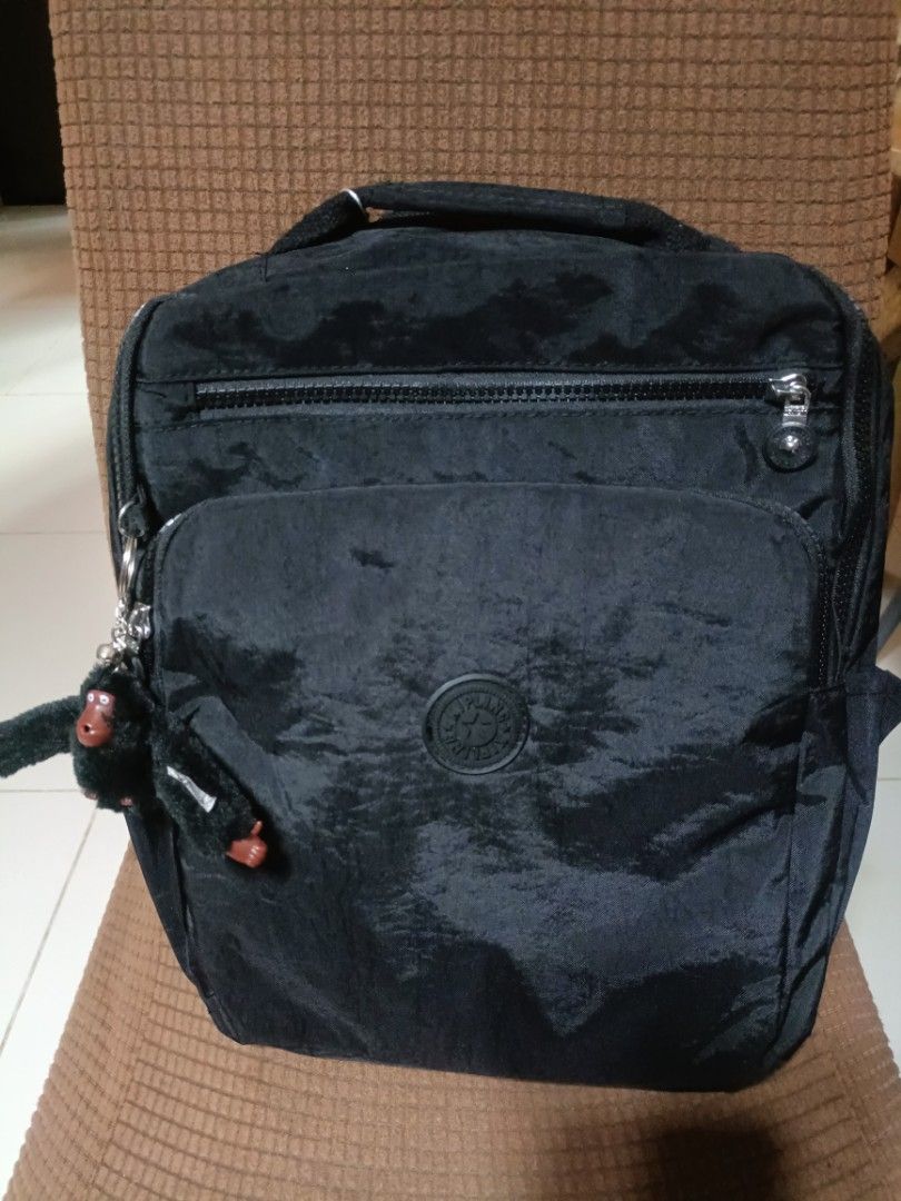 Kipling black nylon backpack with monkey keychain (Category: Backpacks) located in Cebu City. Submitted by dediosmark83726 (Listing ID 1467365384, Image 1). Description: - Brand new authentic Kipling backpack with tag still attached - Crafted from durable, lightweight black crinkled nylon - Multiple zippered front compartments and convenient side pockets - Comfortable, adjustable shoulder straps - Includes the signature furry monkey keychain.