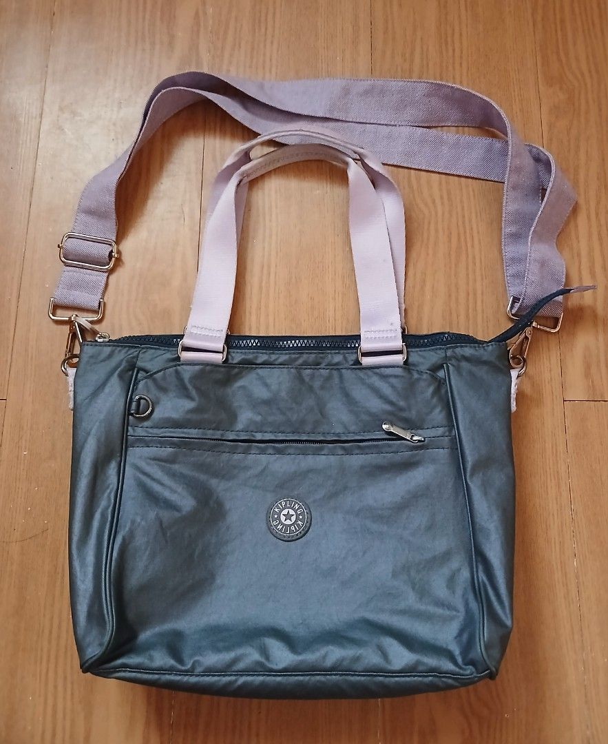 Kipling KI3152-K77 Tote Shoulder Bag (Category: Tote Bags) located in Daraga. Submitted by thethriftcity2024 (Listing ID 1467436913, Image 1). Description: - Authentic Kipling tote bag (Style: KI3152-K77 1020/20553, Made in Vietnam) - Colorway: Dark grey body with pale pink dual top handles and a purple crossbody strap - Storage: Front zippered pocket, interior zipped compartment, and handy slip pockets - Interior: Fully lined with the signature 