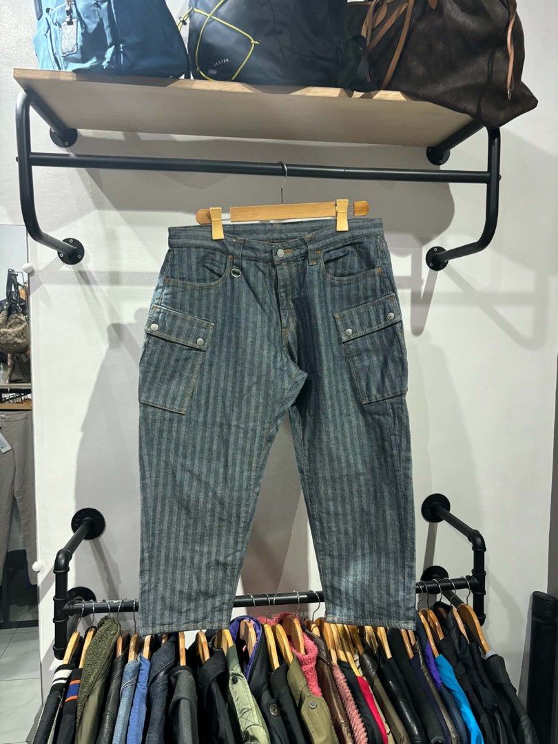 Kojima Genes Herringbone Denim Cargo Pants Size 36 (Category: Jeans) located in Bambang. Submitted by heats777 (Listing ID 1467502374, Image 2). Description: - Brand: Kojima Genes - Style: Herringbone denim cargo pants with vertical stripe pattern - Color: Indigo blue - Size: 36 - Material: 100% cotton (Japanese raw denim) - Features: Multiple utility pockets, metal button fly, genuine leather back patch - Condition: Excellent craftsmanship and q