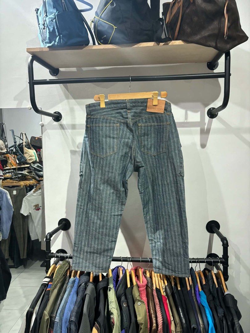 Kojima Genes Herringbone Denim Cargo Pants Size 36 (Category: Jeans) located in Bambang. Submitted by heats777 (Listing ID 1467502374, Image 3). Description: - Brand: Kojima Genes - Style: Herringbone denim cargo pants with vertical stripe pattern - Color: Indigo blue - Size: 36 - Material: 100% cotton (Japanese raw denim) - Features: Multiple utility pockets, metal button fly, genuine leather back patch - Condition: Excellent craftsmanship and q