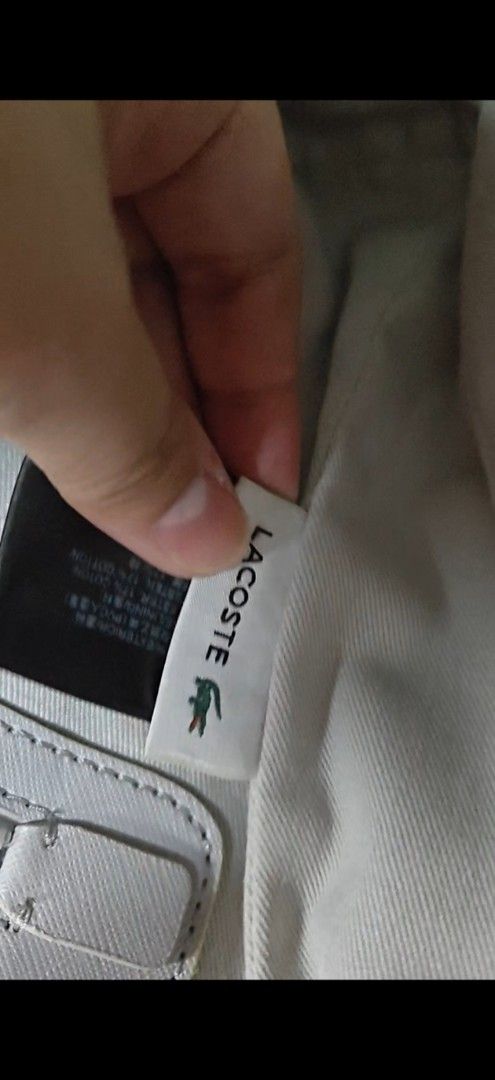 Lacoste Black leather Tote Bag with Embossed Logo (Category: Tote Bags) located in Manila. Submitted by kopishop1109 (Listing ID 1467495451, Image 3). Description: - Brand: Lacoste - Color: Black - Material: Durable canvas with light fabric interior lining - Design: Large embossed crocodile logo on the front - Straps: Double handle design for comfortable carrying - Closure: Secure zip top closure - Compartments: Spacious main compartment with an 