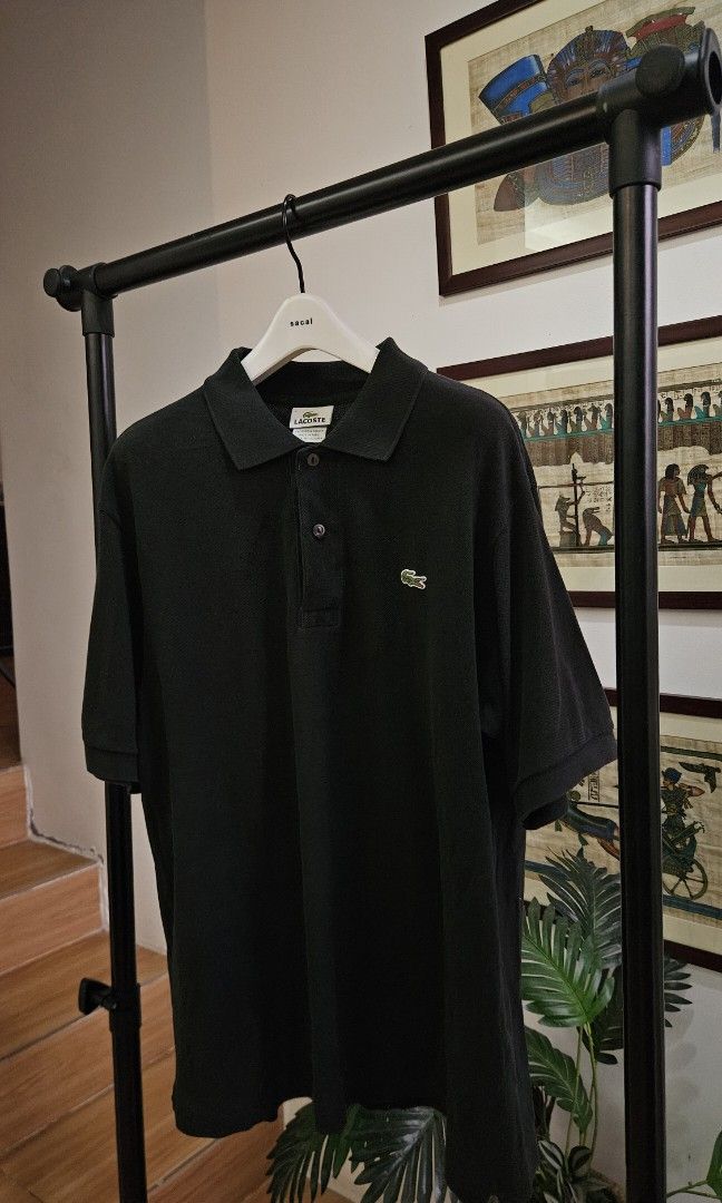 Lacoste Black Polo Shirt Size 5 (Category: Tshirts & Polo Shirts ) located in Alfonso. Submitted by jbcamet (Listing ID 1466878540, Image 1). Description: - Brand: Lacoste - Color: Black - Size: 5 - Material: 100% cotton - Origin: Made in Peru - Details: Classic two-button placket, embroidered crocodile logo, ribbed collar and cuffs.