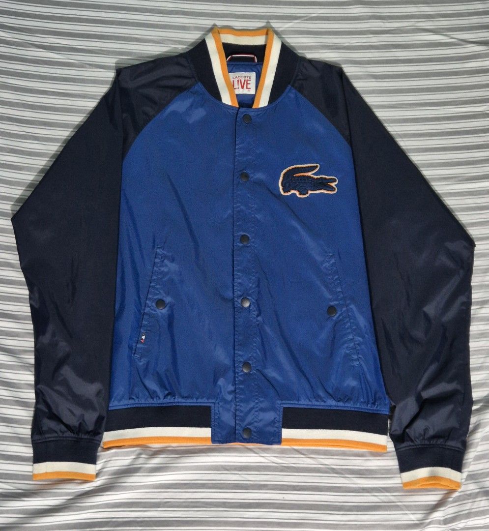 Lacoste Live Varsity Jacket (Category: Coats, Jackets and Outerwear) located in Manila. Submitted by Metronome (Listing ID 1467384843, Image 1). Description: Lacoste Varsity Jacket, 100% LEGIT or your money back. Well-kept, Personal item, 1st owner, not thrifted Excellent Condition 9.6/10 overall, Diko din masyado nagamit, as seen sa photos internal and outside is still immaculate ; except for the button, pls see last pic, Not noticeable when wor
