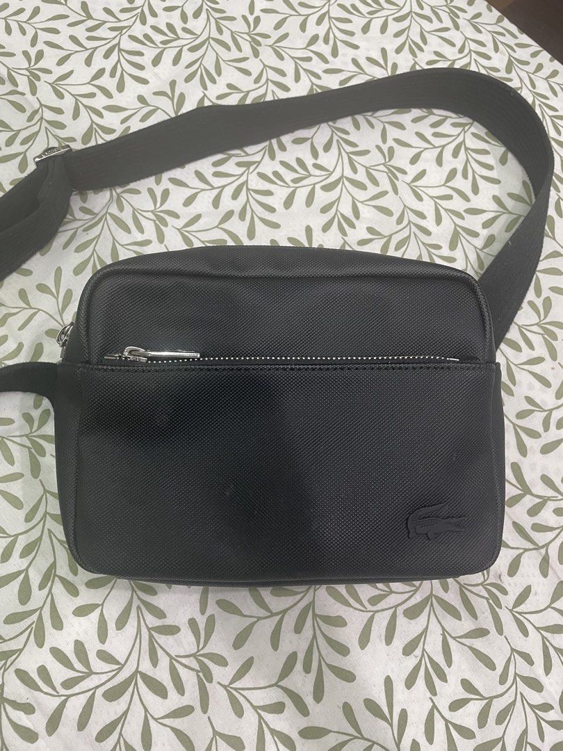 Lacoste Men's Classic Reporter Bag (Category: Sling Bags) located in Manila. Submitted by jem0202_911 (Listing ID 1467479711, Image 1). Description: - Authentic Lacoste black crossbody bag - Adjustable strap for a comfortable fit - Secure main zipped compartment and extra front zip pocket - Textured material with tonal crocodile logo on the bottom corner - Sleek silver zipper hardware - Clean exterior, ideal for daily errands or travel.