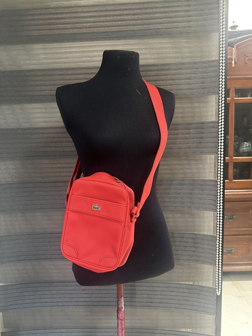 Lacoste red canvas crossbody messenger bag (Category: Sling Bags) located in Quezon City. Submitted by prelovedbagsbygiv (Listing ID 1467467692, Image 1). Description: .