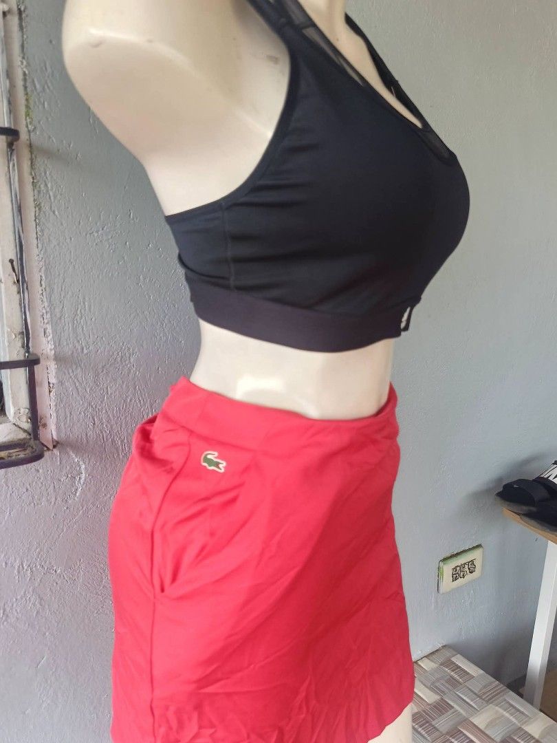 Lacoste Sport Red Skort Size 34 (Category: Skirts) located in Caloocan City. Submitted by abbethany1306 (Listing ID 1467467763, Image 3). Description: - Brand: Lacoste Sport - Item: Athletic Skort - Size: 34 - Color: Vibrant Red - Features: Built-in shorts for comfort and movement, secure elastic waistband - Detail: Signature embroidered green crocodile logo on the side - Condition: Clean fabric throughout, great for sports and tennis.