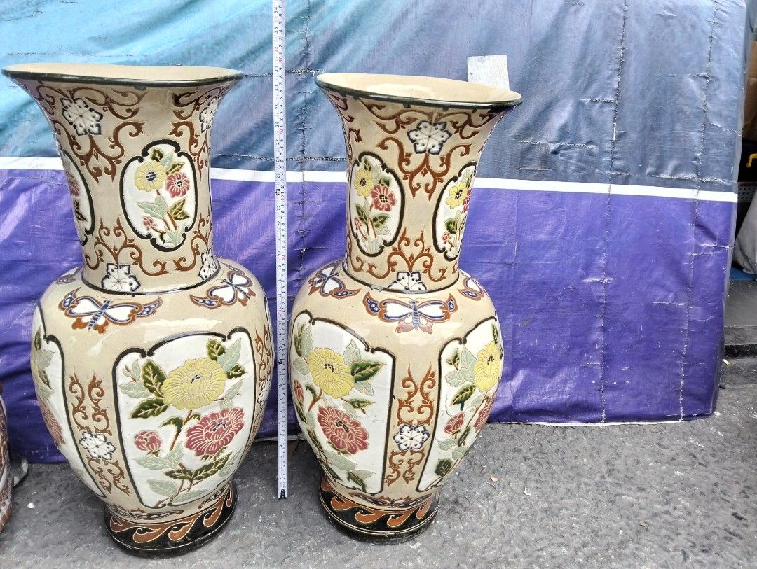 Large Vintage Ceramic Floor Vases Pair Butterfly Floral Pattern (Category: Vases & Decorative Bowls) located in Manila. Submitted by raymundm36884 (Listing ID 1467402341, Image 2). Description: - Type: Pair of large decorative ceramic floor vases - Height: Approx. 31 inches tall - Design: Hand-painted yellow chrysanthemums, pink peonies, butterflies, and intricate scrollwork -P25,000.00 Pair - Finish: Cream base glaze with dark brown trim on rims