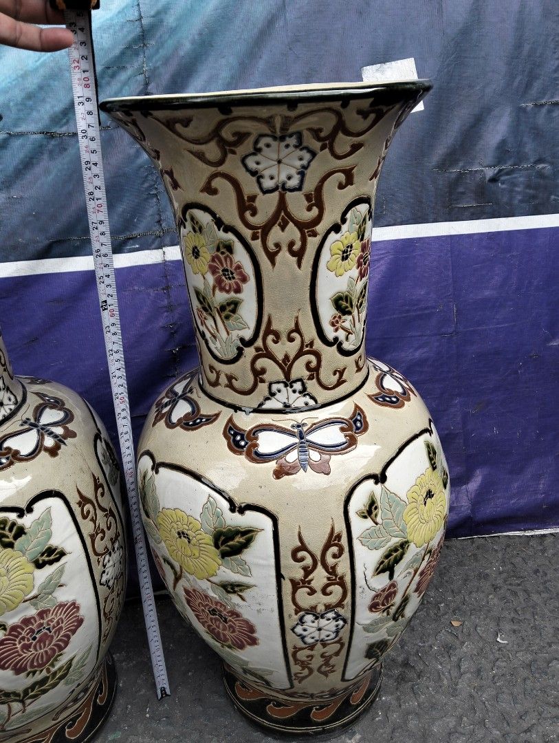 Large Vintage Ceramic Floor Vases Pair Butterfly Floral Pattern (Category: Vases & Decorative Bowls) located in Manila. Submitted by raymundm36884 (Listing ID 1467402341, Image 1). Description: - Type: Pair of large decorative ceramic floor vases - Height: Approx. 31 inches tall - Design: Hand-painted yellow chrysanthemums, pink peonies, butterflies, and intricate scrollwork -P25,000.00 Pair - Finish: Cream base glaze with dark brown trim on rims