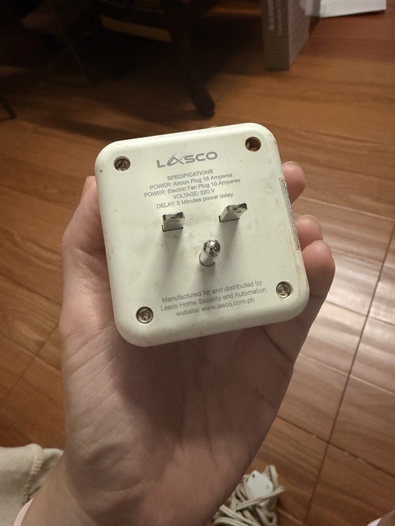 Lasco Smart Plug (Category: Electrical, Adaptors & Sockets) located in Quezon City. Submitted by shop.leilou (Listing ID 1467465429, Image 2). Description: - Brand: Lasco Home Security and Automation - Built-in 5-minute power delay to protect appliances from power surges - Designed for 220V power systems - Heavy-duty capacity: Supports up to 16A (aircon) and 10A (electric fan) - Design: Compact white square body with standard back prongs and mixe