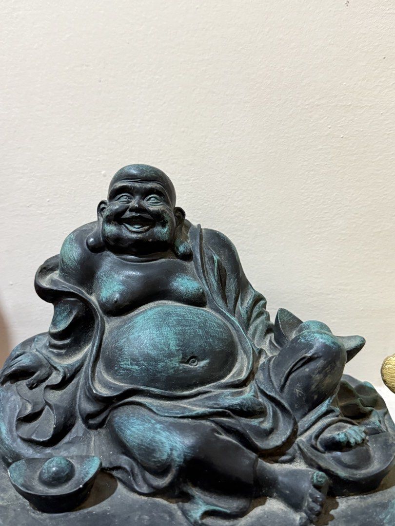 Laughing Buddha bronze tone statue home decor (Category: Figurines & Statues) located in Manila. Submitted by chestercor71092 (Listing ID 1467435842, Image 1). Description: - Material: Heavy resin or metal with intentional aged weathering effects - Design: Traditional joyful Laughing Buddha with large exposed belly, holding ingots - Finish: Antique bronze with verdigris patina detailing on robes and base - Placement: Ideal statement piece for liv