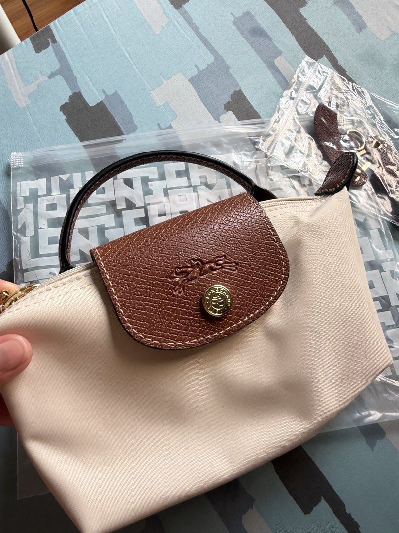 LC Mini Le Pliage Mini Top Handle Bag - Paper (Category: Luxury Bags & Wallets) located in Imus. Submitted by clongy.cn (Listing ID 1467380282, Image 2). Description: LC Mini Le Pliage Top Handle Bag Paper mini Authentic Quality - Material: Durable paper nylon body with elegant brown leather flap and top handle - Hardware: Premium gold-tone hardware - Closure: Secure zipper closure with a snap button flap - Includes a detachable leather shoulder 