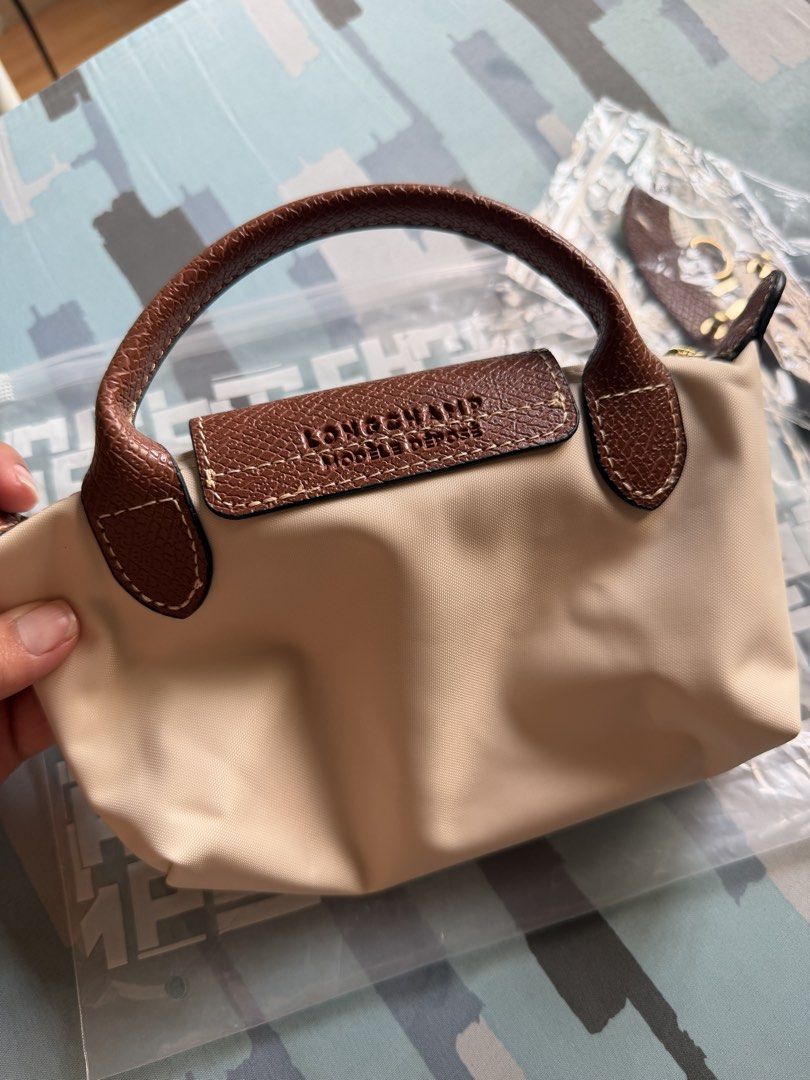 LC Mini Le Pliage Mini Top Handle Bag - Paper (Category: Luxury Bags & Wallets) located in Imus. Submitted by clongy.cn (Listing ID 1467380282, Image 3). Description: LC Mini Le Pliage Top Handle Bag Paper mini Authentic Quality - Material: Durable paper nylon body with elegant brown leather flap and top handle - Hardware: Premium gold-tone hardware - Closure: Secure zipper closure with a snap button flap - Includes a detachable leather shoulder 