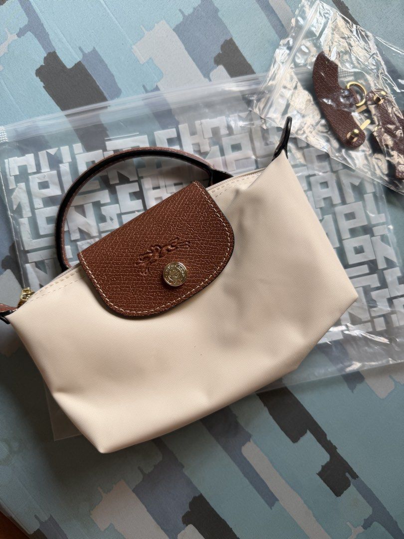 LC Mini Le Pliage Mini Top Handle Bag - Paper (Category: Luxury Bags & Wallets) located in Imus. Submitted by clongy.cn (Listing ID 1467380282, Image 1). Description: LC Mini Le Pliage Top Handle Bag Paper mini Authentic Quality - Material: Durable paper nylon body with elegant brown leather flap and top handle - Hardware: Premium gold-tone hardware - Closure: Secure zipper closure with a snap button flap - Includes a detachable leather shoulder 