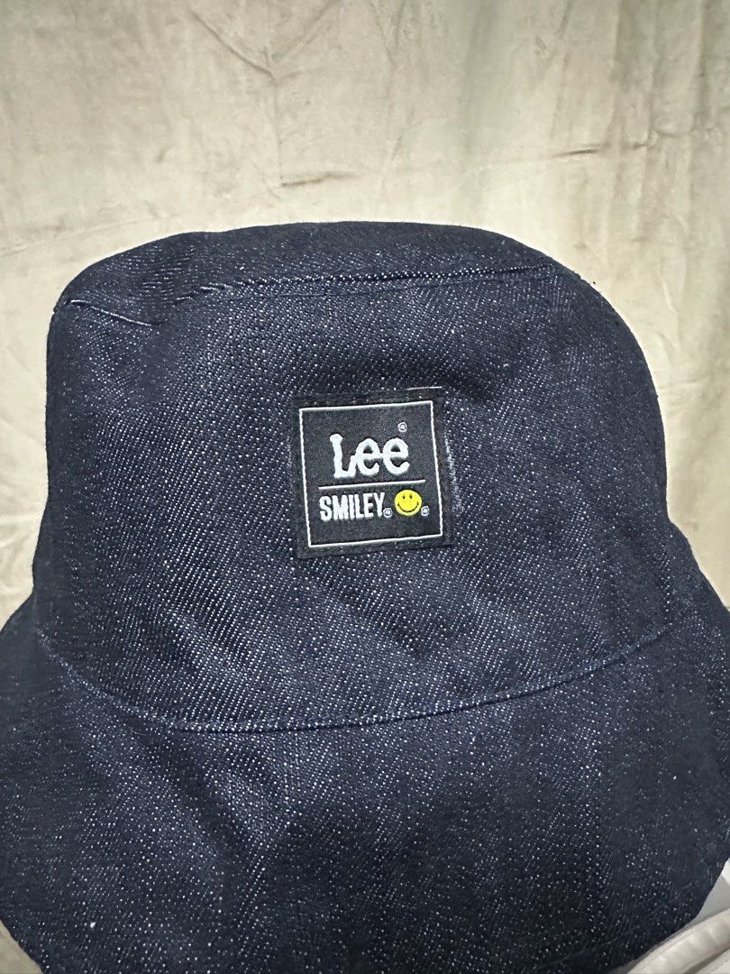 Lee x Smiley Reversible Denim and Stripe Bucket Hat (Category: Hats & Beanies) located in Manila. Submitted by jmdrgooddeals (Listing ID 1467540385, Image 3). Description: - Official Lee and Smiley collaboration bucket hat - Reversible design featuring dark denim on Side A and red and white vertical stripes on Side B - Branded patches included on both sides - Clean fabric with zero flaws, holes, or stains - Versatile accessory to elevate your dai
