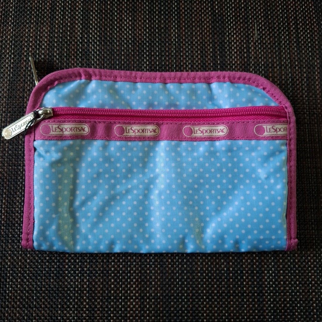 LeSportsac Blue Polka Dot Long Wallet (Category: Wallets & Card holders) located in Don Carlos. Submitted by PphiXi_Finds (Listing ID 1467439770, Image 1). Description: - Design: Light blue with white polka dots and hot pink trim - Interior: Vibrant bright pink lining - Organization: Multiple card slots, separate compartments, and a zip coin pocket - Functionality: Smooth-running zippers and lots of space for cash and cards - Condition: Great and