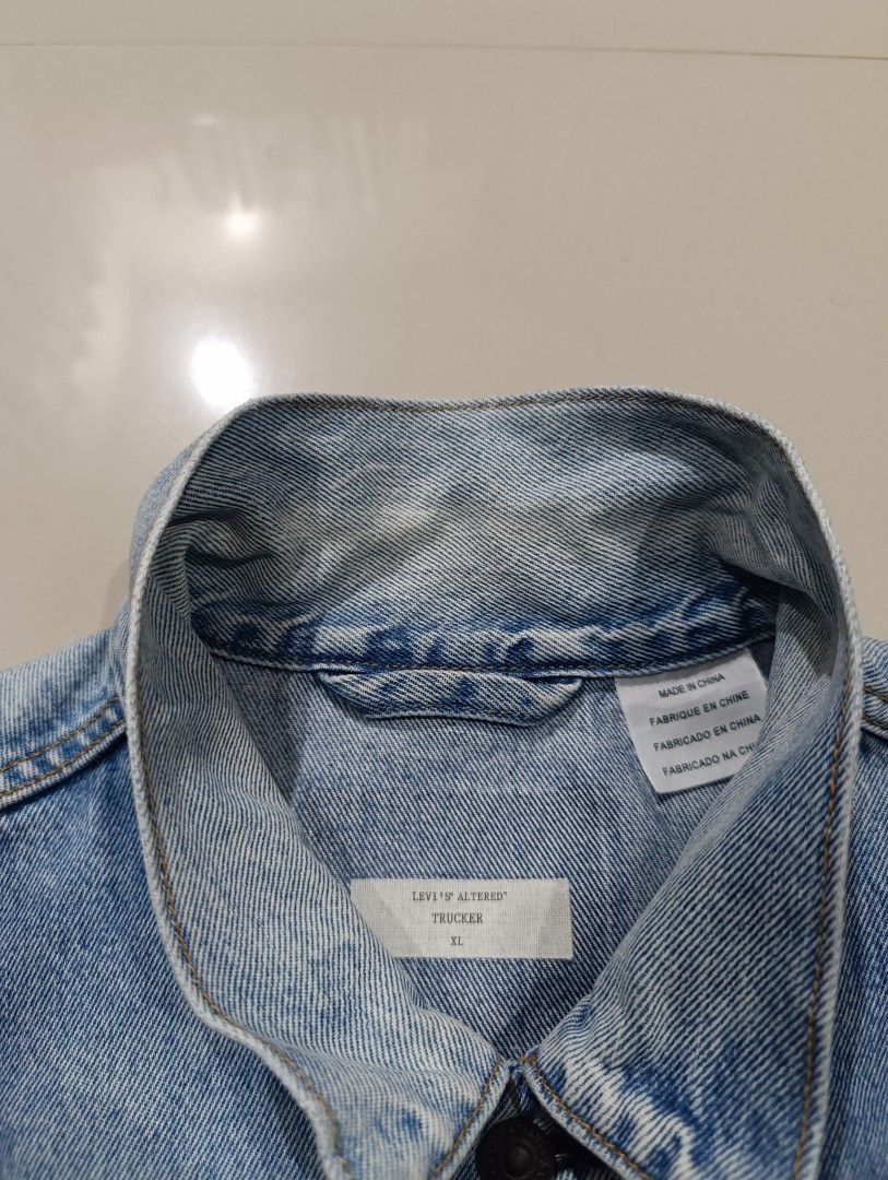 Levi's Altered Trucker Jacket Size XL (Category: Coats, Jackets and Outerwear) located in Davao. Submitted by idioticthrifter (Listing ID 1467528421, Image 3). Description: - Brand: Levi's - Style: Altered Trucker Jacket - Wash: Light denim - Size: XL (Oversized fit) - Details: Button-front closure, classic red tab on chest pockets, side welt pockets - Finish: Raw hem, frayed sleeve cuffs, and intentional distressing - Origin: Made in China - Con