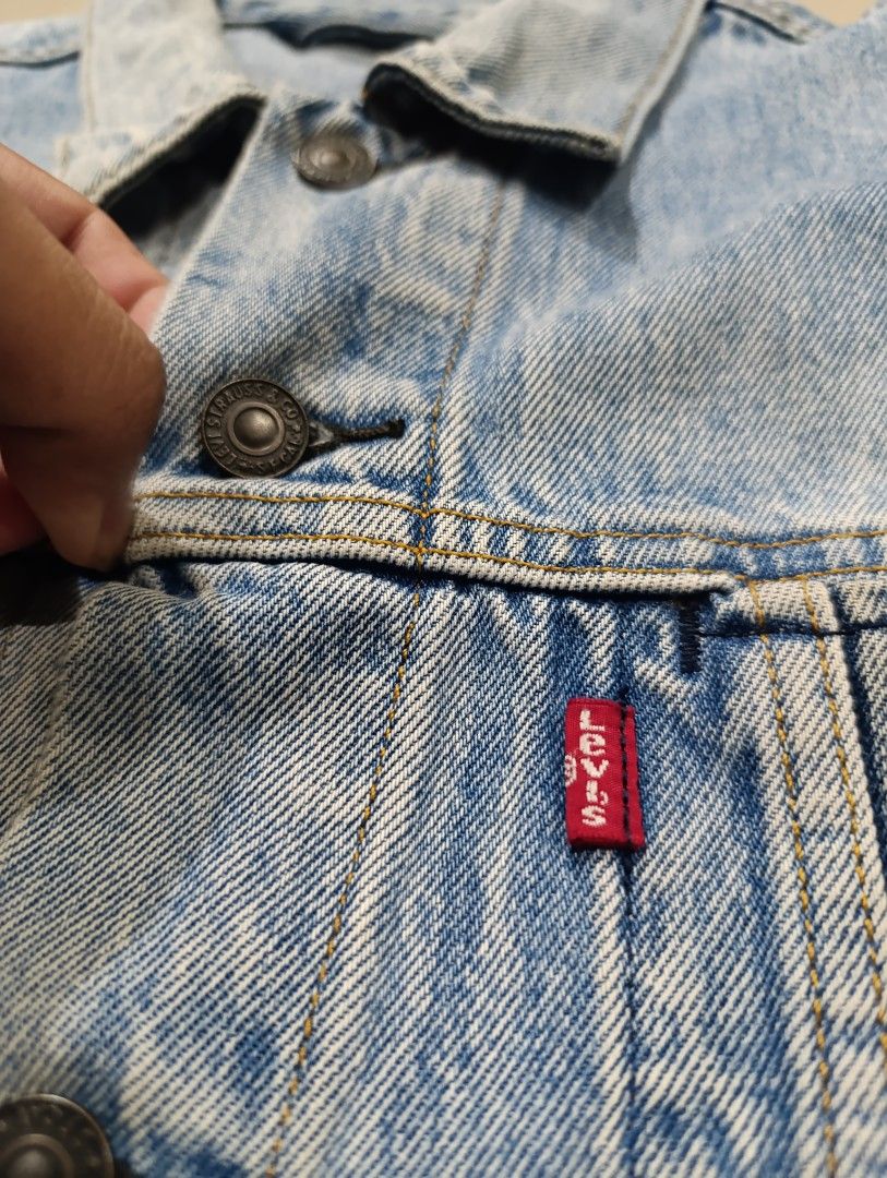 Levi's Altered Trucker Jacket Size XL (Category: Coats, Jackets and Outerwear) located in Davao. Submitted by idioticthrifter (Listing ID 1467528421, Image 2). Description: - Brand: Levi's - Style: Altered Trucker Jacket - Wash: Light denim - Size: XL (Oversized fit) - Details: Button-front closure, classic red tab on chest pockets, side welt pockets - Finish: Raw hem, frayed sleeve cuffs, and intentional distressing - Origin: Made in China - Con