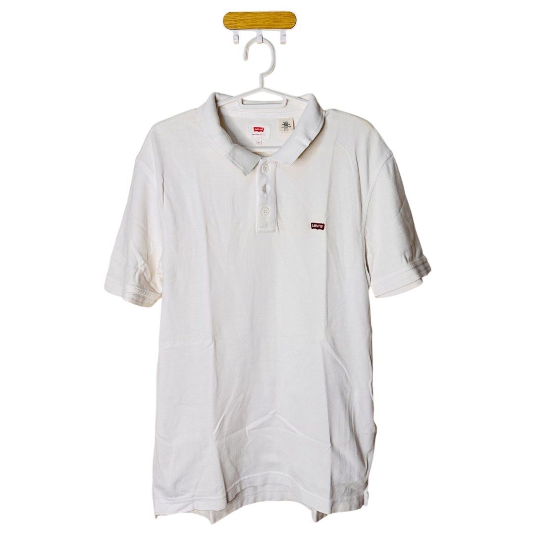 Levi's White Polo Shirt (Category: Tshirts & Polo Shirts ) located in Pasay City. Submitted by el.sole (Listing ID 1467526948, Image 1). Description: - Brand: Levi's - Color: White - Material: Classic cotton knit fabric - Design: Three-button placket, attached collar, and short sleeves with ribbed cuffs - Details: Small red Levi's tab logo on the left chest - Fit: Standard fit, clean solid color style - Condition: Great for casual or smart-casual