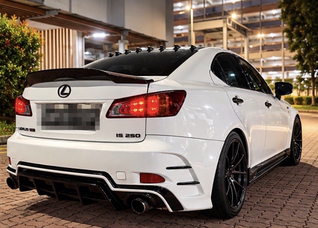 Lexus IS250 2.5 (A) (Category: Used Cars) located in Singapore. Submitted by reallymeh168 (Listing ID 1467577278, Image 2). Description: Reliable 2.5L V6 Engine White Lexus IS 250 sedan with custom black carbon fiber hood and racing stripes. Aggressive body kit, rear diffuser, and roof spoiler. Black multi-spoke alloy wheels with red brake calipers. Custom interior features black leather seats with red diamond stitching. Large vertical touchscree