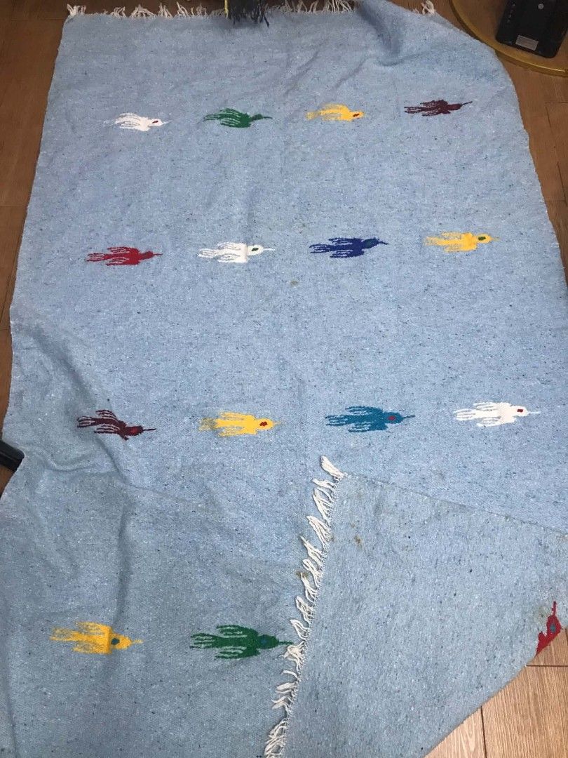Light blue woven with colorful bird patterns (Category: Bedding & Towels) located in Imus. Submitted by stop_shop7 (Listing ID 1467439972, Image 2). Description: - Color: Light blue with colorful embroidered bird motifs - Details: White fringe along the edges - Material & Feel: Soft woven texture - Need wash, washable stain.