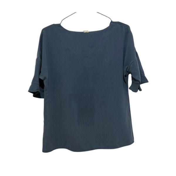 Liola Blue Short Sleeve Blouse (Category: Blouses) located in San Fernando. Submitted by lovingthings1 (Listing ID 1467389794, Image 2). Description: - Brand/Style: Liola - Color: Solid dark blue - Details: Short sleeves with ruffled cuffs, wide boat neckline - Fabric: Smooth, drapes nicely - Versatility: Ideal for daily casual wear or office styling - Pairing: Easy to match with jeans or skirts.