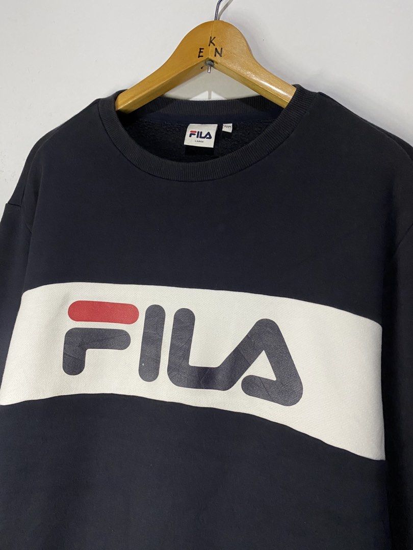 LONG SLEEVE (Category: Hoodies) located in Jaen. Submitted by oshimamark58418 (Listing ID 1467453994, Image 2). Description: - Brand: FILA - Style: Long sleeve sweatshirt / pullover with fleece lining - Size: Large (Regular Fit) - Color: Dark blue with white chest band and red sleeve accents - Condition: Good pre-loved condition (4/5) - Features iconic FILA logo across the chest.
