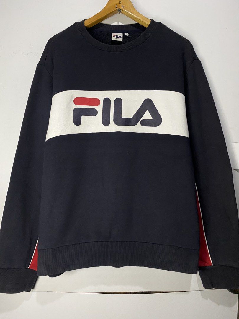 LONG SLEEVE (Category: Hoodies) located in Jaen. Submitted by oshimamark58418 (Listing ID 1467453994, Image 1). Description: - Brand: FILA - Style: Long sleeve sweatshirt / pullover with fleece lining - Size: Large (Regular Fit) - Color: Dark blue with white chest band and red sleeve accents - Condition: Good pre-loved condition (4/5) - Features iconic FILA logo across the chest.