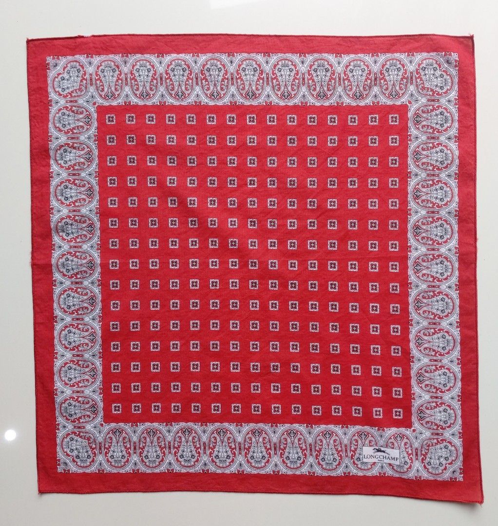 Longchamp Paris Red Paisley Handkerchief (Category: Handkerchief & Pocket Squares) located in Lapu Lapu. Submitted by agnesapm_29813 (Listing ID 1467508588, Image 3). Description: - Brand: Longchamp Paris - Material: 100% Cotton, Made in Italy - Design: Classic paisley borders with repeating small square patterns in the center - Measurements: 16.5 x 16.5 inches - Details: Includes original Longchamp label and 'Made in Italy' tag - Styling: Perfec